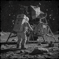 Apollo 11 astronaut on the moon with lunar module in background