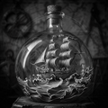 Sailing ship inside a bottle with intricate detailing on a dark background