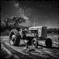 Vintage tractor on a farm with a starry night sky and constellation.