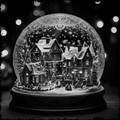 Decorative snow globe with a winter scene featuring houses and trees, illuminated against a dark background.