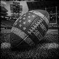 Football with American flag pattern on grass field